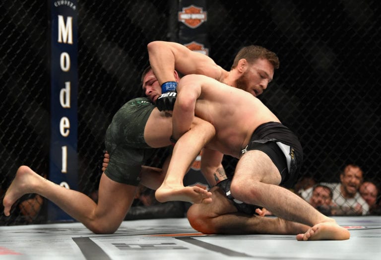 Conor McGregor of Ireland tackles Khabib Nurmagomedov of Russia in their UFC lightweight championship bout during the UFC 229 event