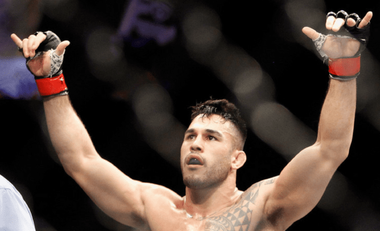 Middleweight Brad Tavares raises his arms in victory