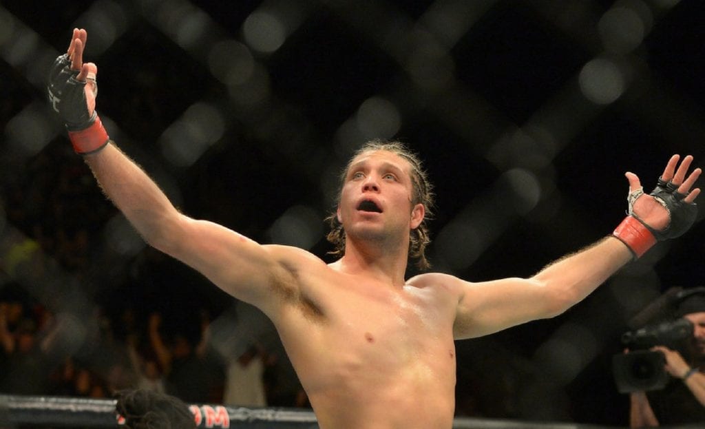 Brian Ortega raises his arms after winning his featherweight bout