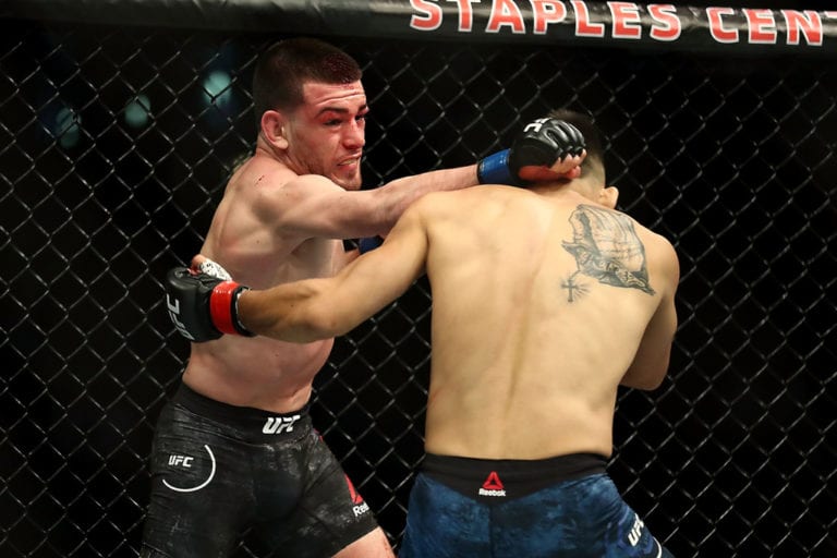Jose Torres throws a punch at Alex Perez in the first round in the featherweight bout during UFC 227