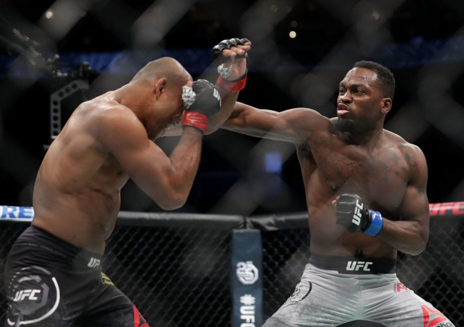 Derek Brunson punches Ronaldo "Jacare" Souza of Brazil in their middleweight bout during UFC Fight Night