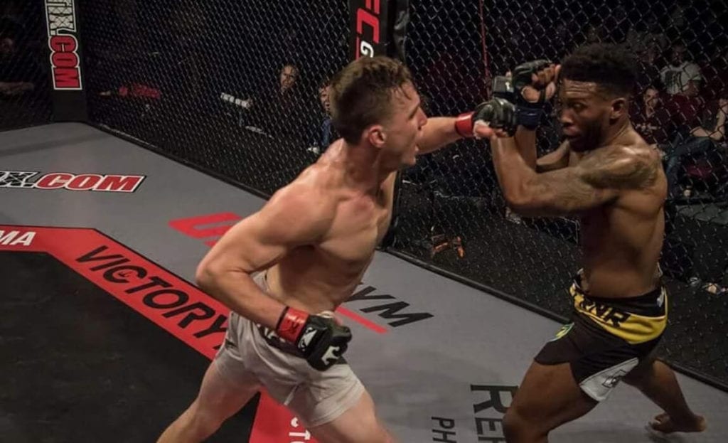 Josh Streaker lands a left punch in his MMA fight at Victory FC 60