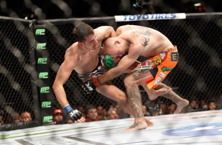 Myles Jury (L) is taken down by Donald Cerrone in a lightweight fight during UFC 182