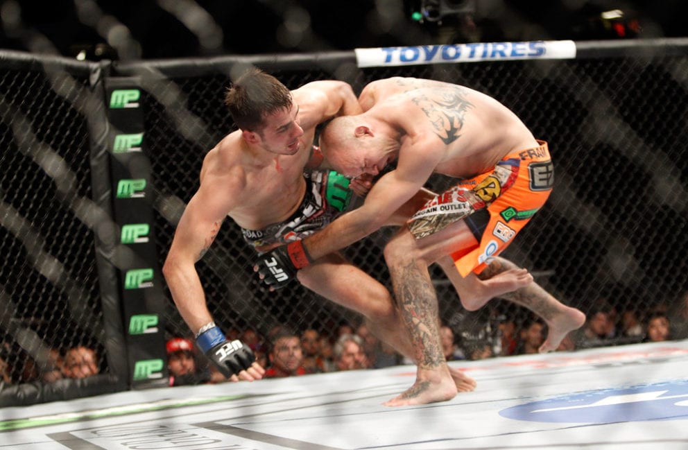 Myles Jury (L) is taken down by Donald Cerrone in a lightweight fight during UFC 182