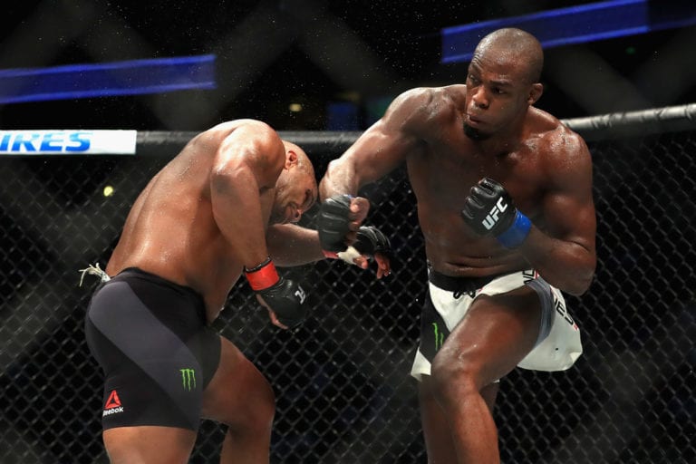 Daniel Cormier (L) fights Jon Jones in the Light Heavyweight title bout during UFC 214
