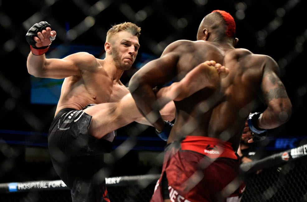 Dan Hooker of New Zealand kicks Marc Diakiese of Congo in their lightweight bout during the UFC 219 event