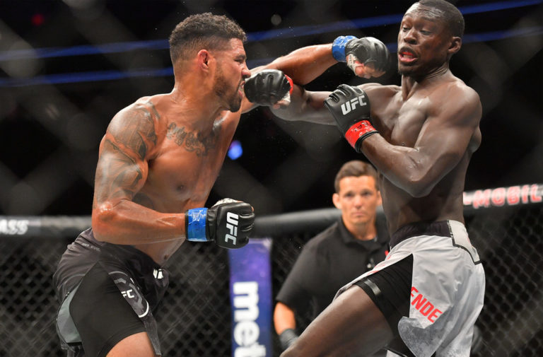 Max Griffin (L) throws a punch against Curtis Millender during their welterweight fight at T-Mobile Arena on July 7, 2018 in Las Vegas