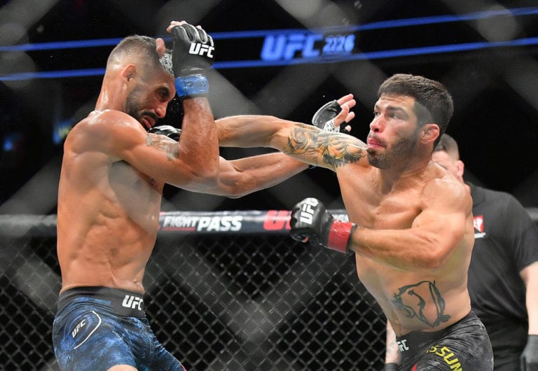 Raphael Assuncao (R) lands a punch against Rob Font during their bantamweight fight at T-Mobile Arena on July 7, 2018 in Las Vegas, Nevada. Assuncao won by unanimous decision