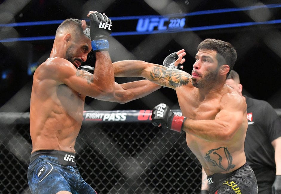 Raphael Assuncao (R) lands a punch against Rob Font during their bantamweight fight at T-Mobile Arena on July 7, 2018 in Las Vegas, Nevada. Assuncao won by unanimous decision