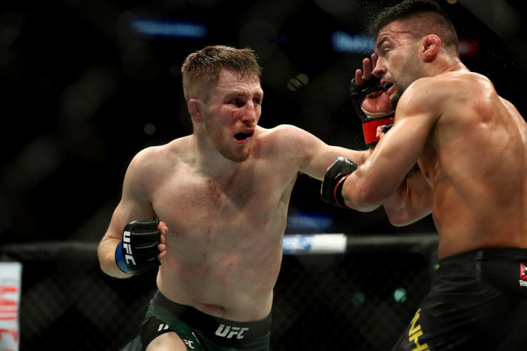 Brett Johns punches Pedro Munhoz in the third round in the bantamweight bout during UFC 227