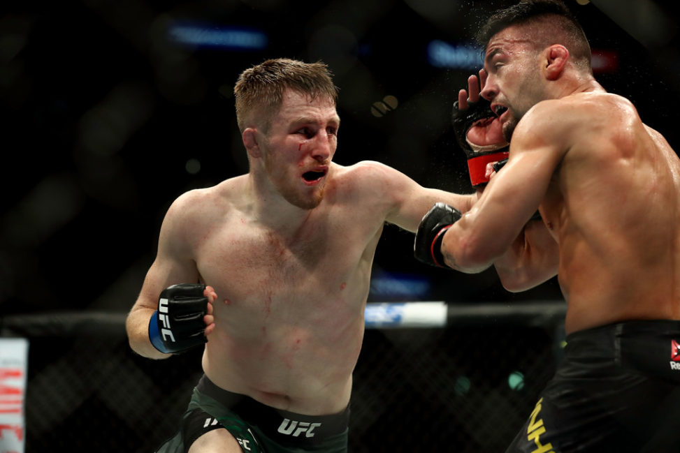 Brett Johns punches Pedro Munhoz in the third round in the bantamweight bout during UFC 227