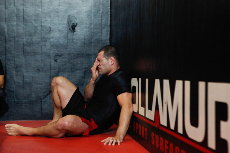 UFC fighter Cain Velasquez rests during a media day workout