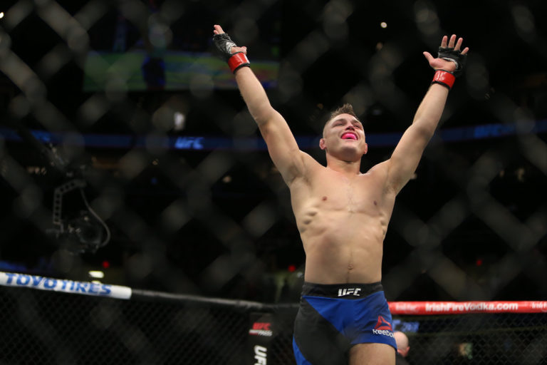 Drew Dober raises his hands at the end of a fight at UFC 203