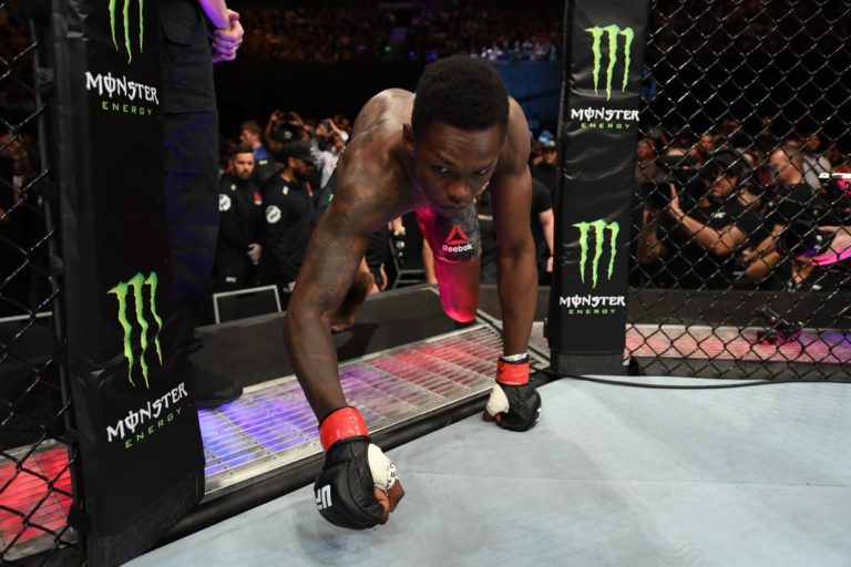 Israel Adesanya steps into the cage at UFC 234