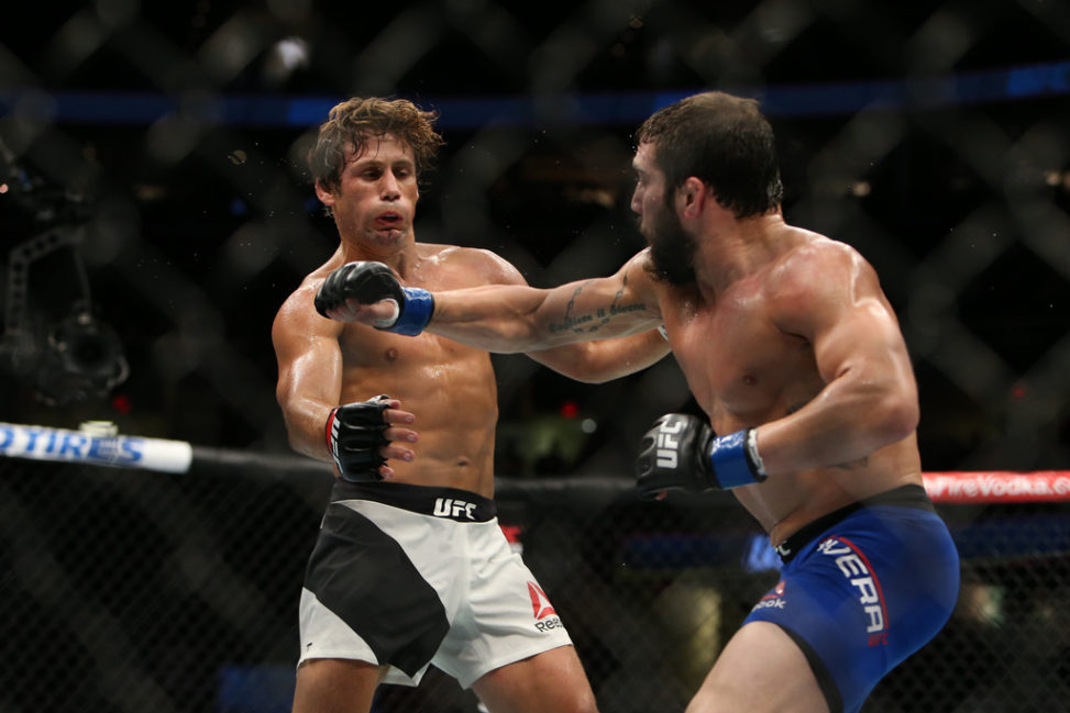 Jimmie Rivera punches Urijah Faber during the UFC 203 event