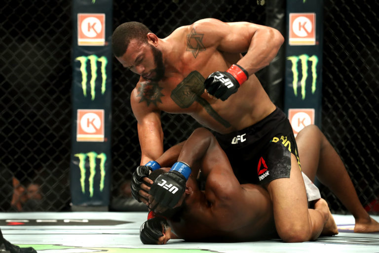 Thiago Santos beats on Kevin Holland in the third round in the middleweight bout during UFC 227