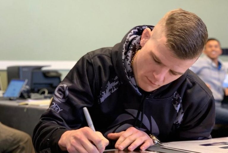 Grant Dawson signs UFC posters before his debut