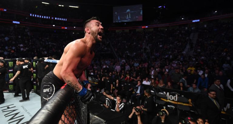 Pedro Munhoz leaps the cage after a knockout finish against Cody Garbrandt in the UFC