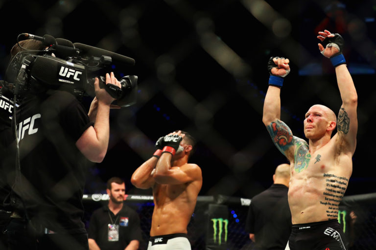 Jon Tuck of the USA looks dejected as Josh Emmett (R) of the USA celebrates victory after their Lightweight bout
