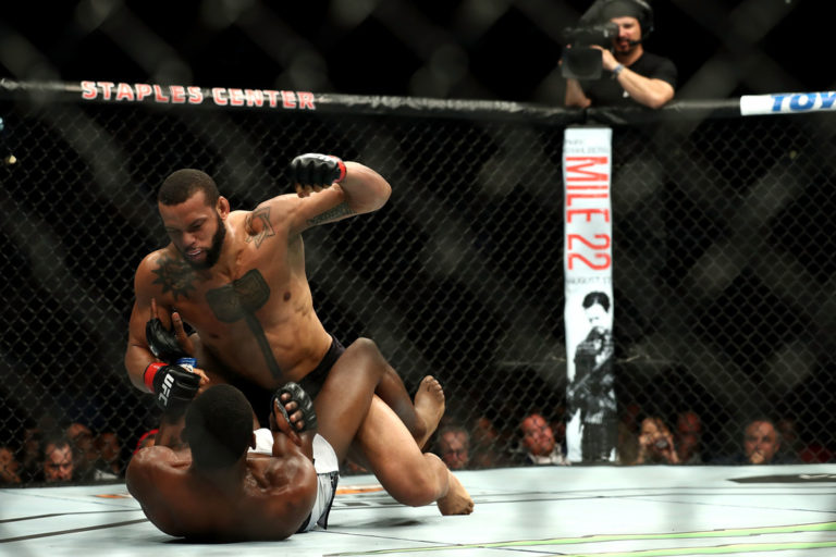 Thiago Santos beats on Kevin Holland in the first round in the middleweight bout during UFC 227