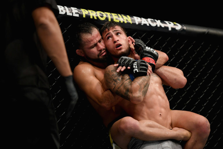Jussier Formiga of Brazil takes to the back of Sergio Pettis in their flyweight bout during the UFC 229