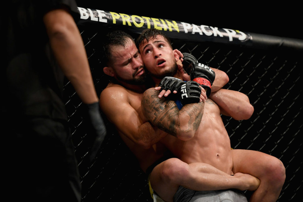 Jussier Formiga of Brazil takes to the back of Sergio Pettis in their flyweight bout during the UFC 229