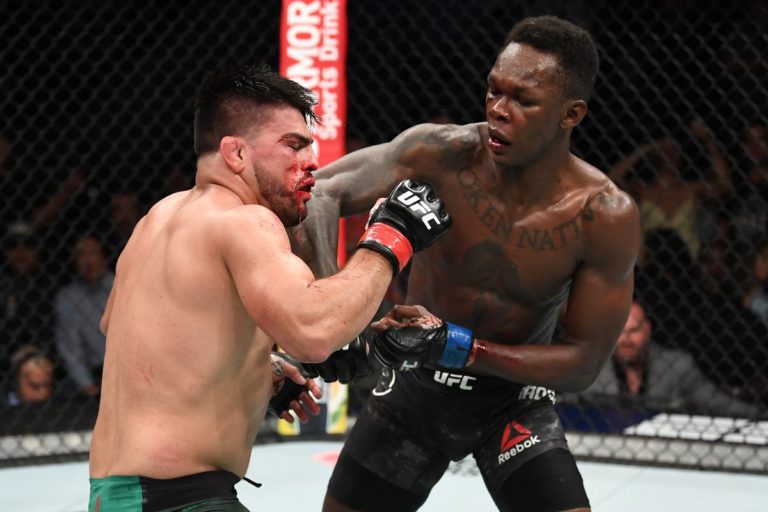 Israel Adesanya lands a left punch against Kelvin Gastelum at UFC 236