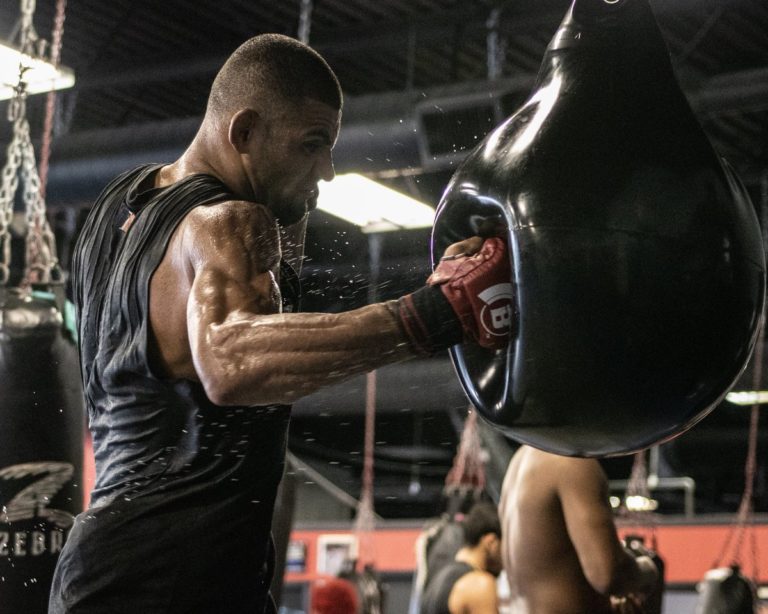Douglas Lima hits the bag during a training session