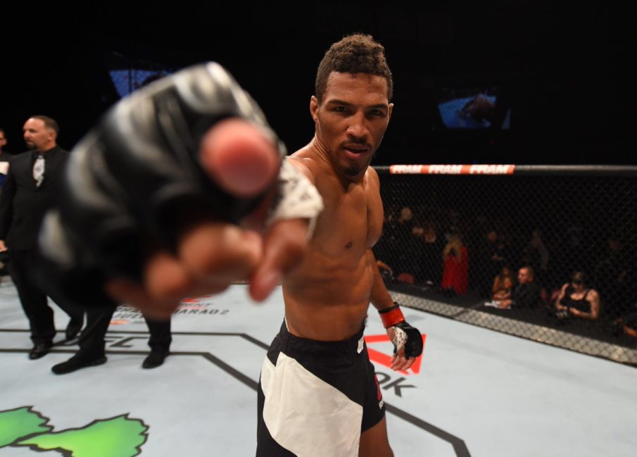 Kevin Lee points toward the camera inside the UFC Octagon
