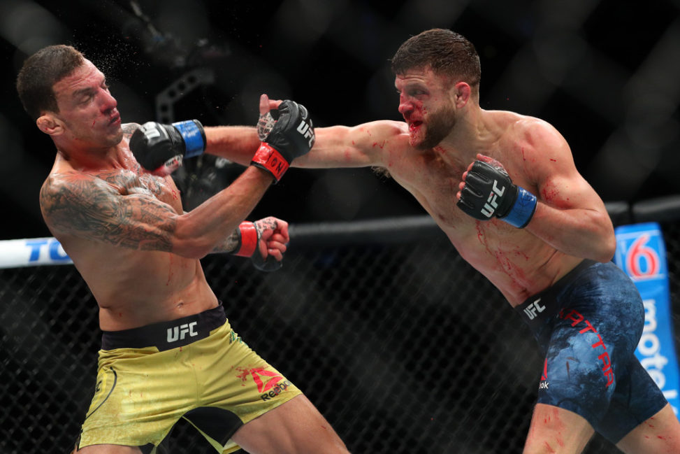 Calvin Kattar (R) lands a right hand to the head of Renato Moicano (L) during their featherweight bout at UFC 223