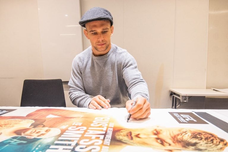 Nick Hein signs UFC Fight Night 153 posters before UFC Stockholm