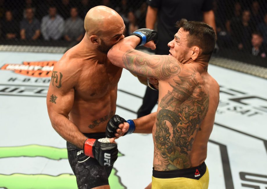 Rafael dos Anjos slices Robbie Lawler with a left elbow