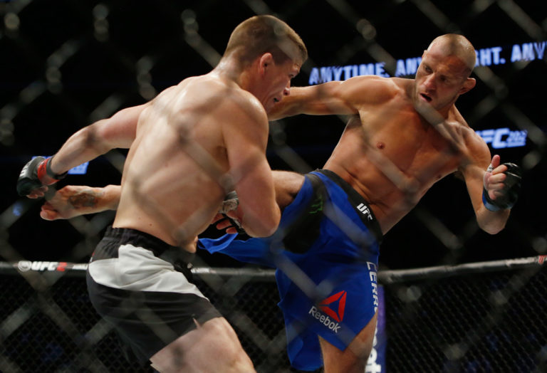 Donald Cerrone (R) kicks Rick Story during their welterweight bout at the UFC 202