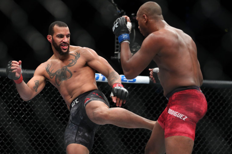 Devin Clark (L) lands a kick on Mike Rodriguez (R) during their light heavyweight bout at UFC 223