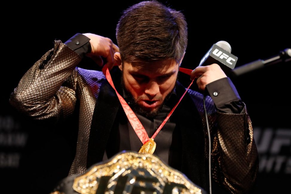 Henry Cejudo with his Olympic gold medal and UFC title