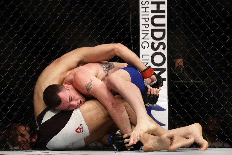 Dong Hyun Kim of South Korea (L) fights Colby Covington of United States (R) in the Welterweight Bout