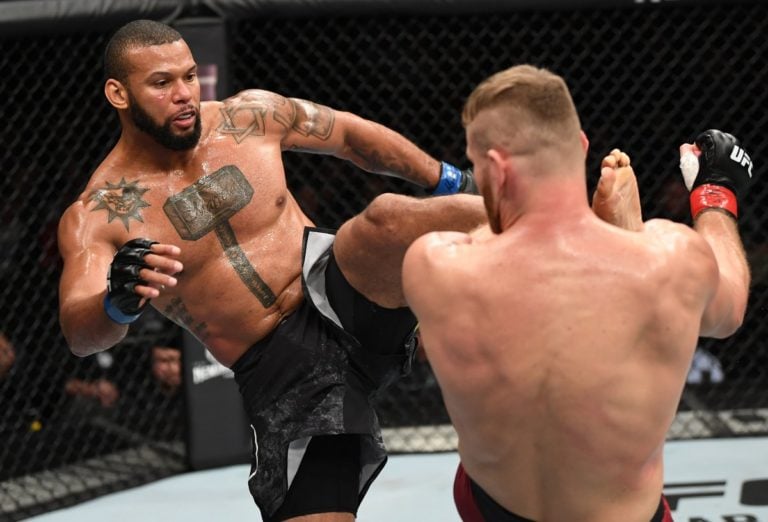 Thiago Santos hits Jan Blachowicz with a head kick