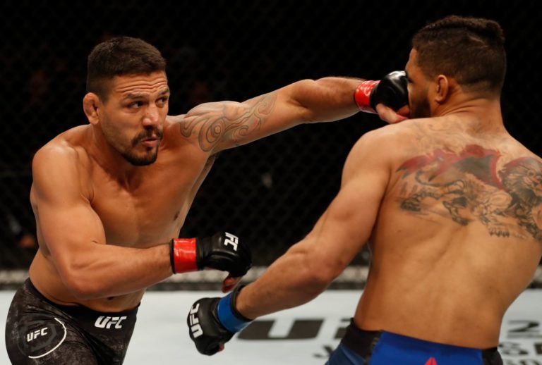 Rafael dos Anjos lands a punch against Kevin Lee