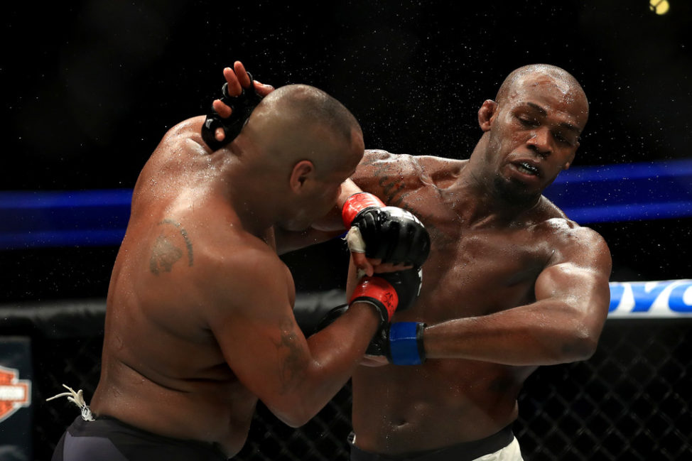 Daniel Cormier (L) fights Jon Jones in the Light Heavyweight title bout during UFC 214