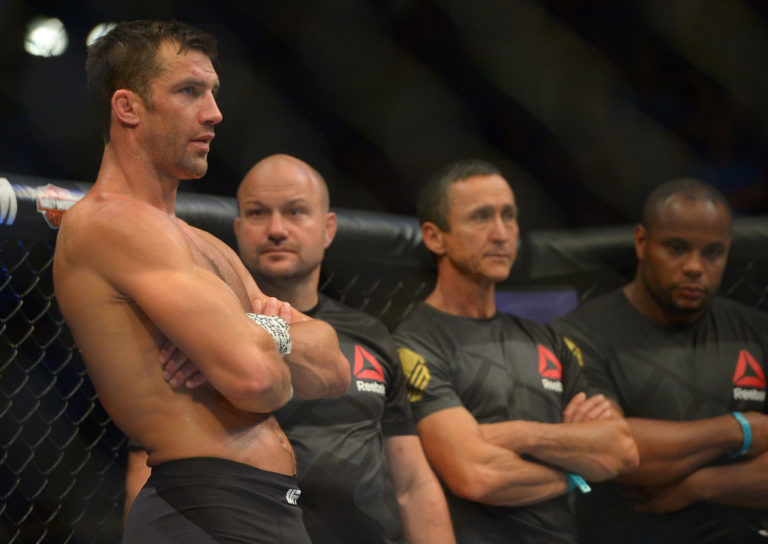 Luke Rockhold stands in the cage after he was defeated by Michael Bisping during their middleweight championship bout