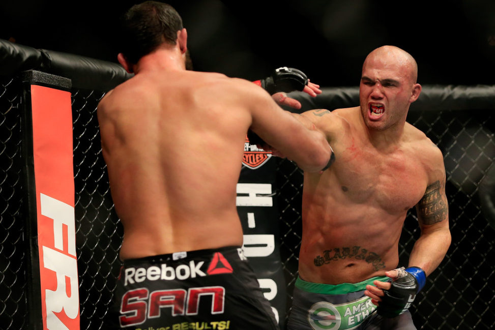 Robbie Lawler punches Johny Hendricks in their welterweight title fight during the UFC 181