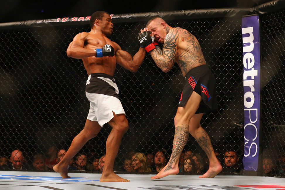 Francisco Trinaldo (L) punches Ross Pearson in their lightweight bout during UFC Fight Night 81