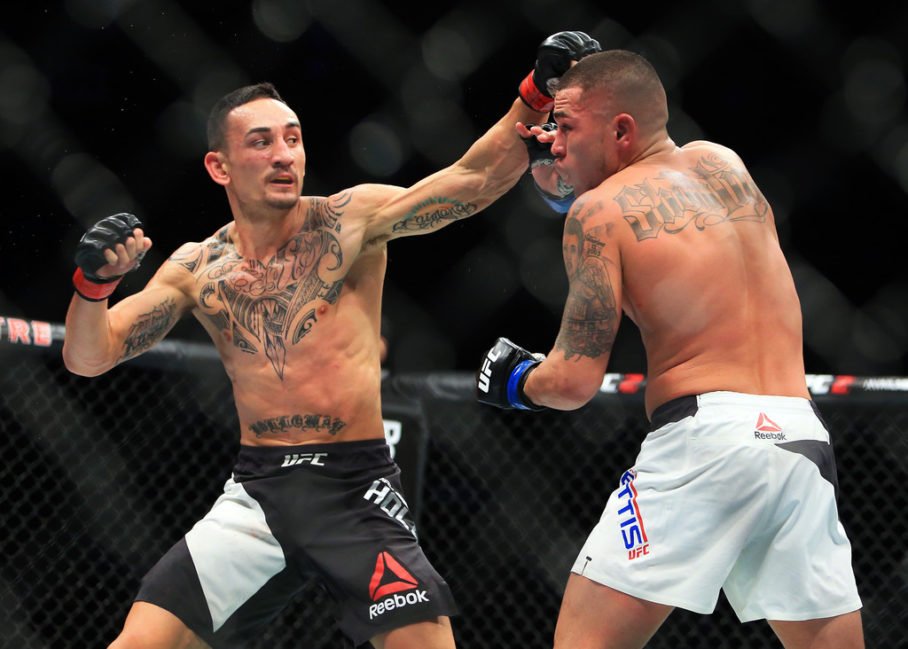 Max Holloway (L) of the United States fights Anthony Pettis (R) of the United States for the Interim Featherweight Title during the UFC 206 event