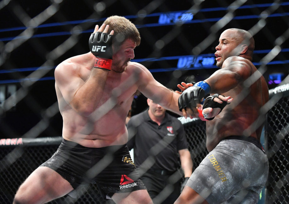 Stipe Miocic (L) throws a punch against Daniel Cormier during their heavyweight championship fight
