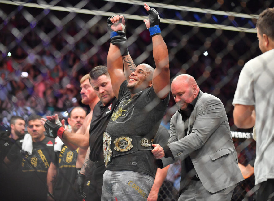 UFC President Dana White (R) places the championship belt around the waist of Daniel Cormier