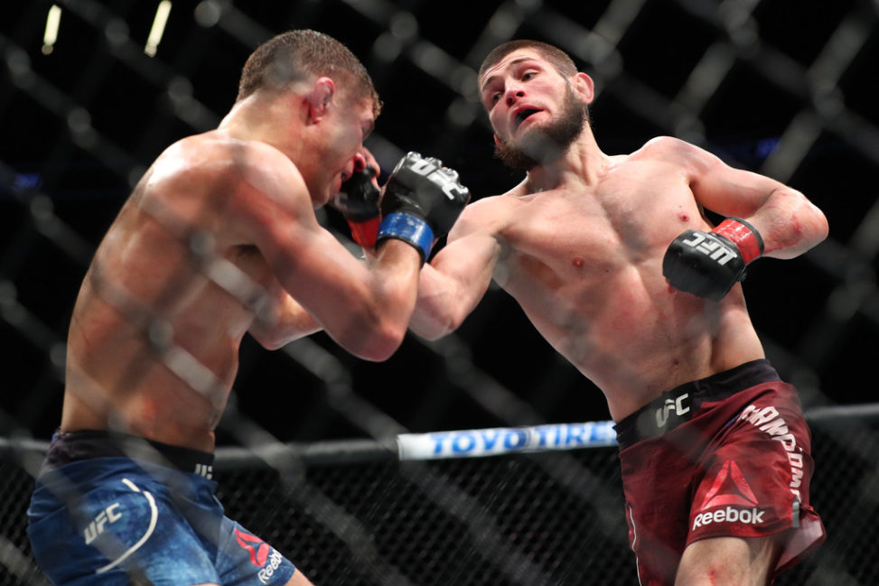 Khabib Nurmagomedov (R) lands a right uppercut on Al Iaquinta (L) during their UFC lightweight championship bout at UFC 223