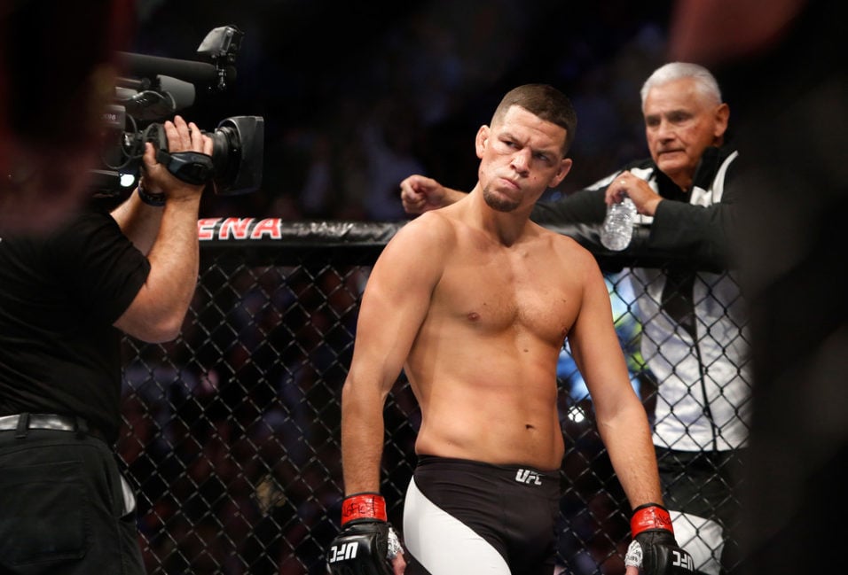 Nate Diaz eyes Conor McGregor from across the Octagon before their welterweight rematch at the UFC 202 event