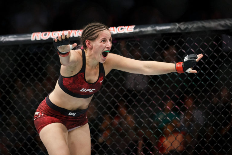 Sarah Moras celebrates her victory against Ashley Evans-Smith during UFC 215