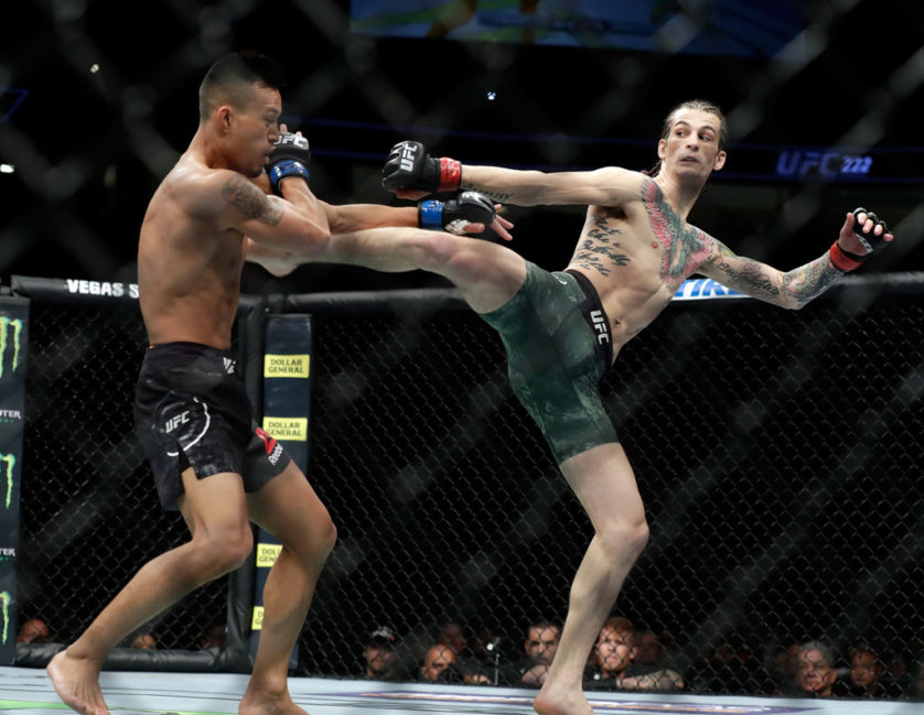 Sean O'Malley (R) kicks Andre Soukhamthath during their bantamweight bout during UFC 222