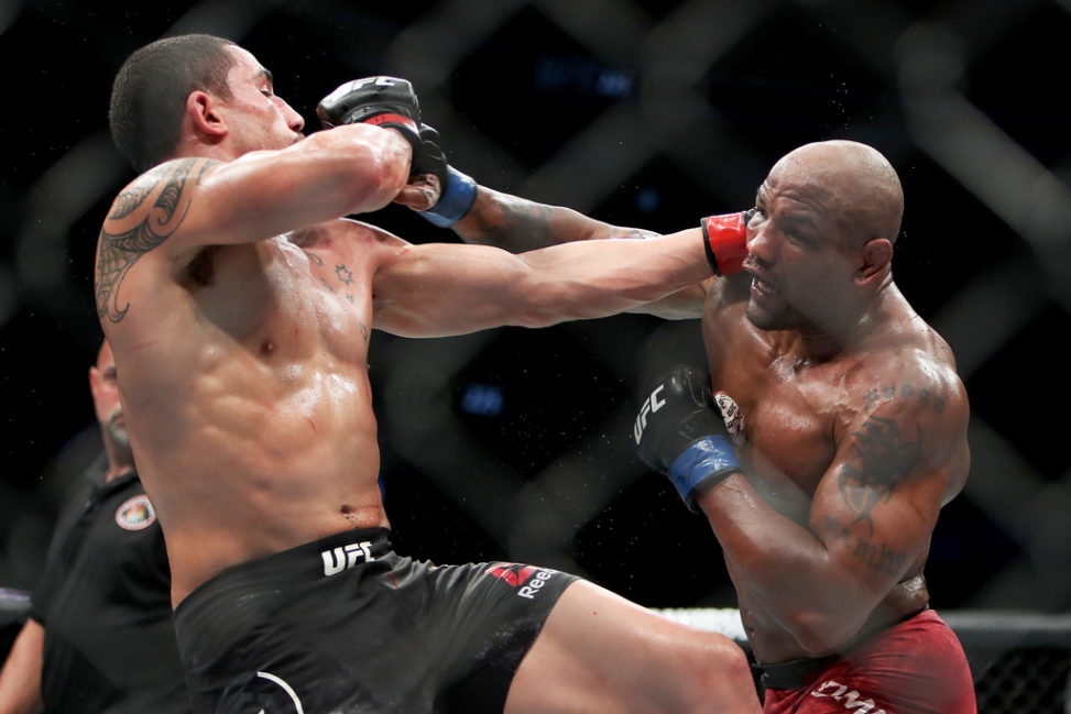 Yoel Romero of Cuba (R) and Robert Whittaker of New Zealand (L) each attempt a punch in the fifth round